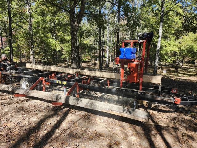 The sawmill set up under the trees