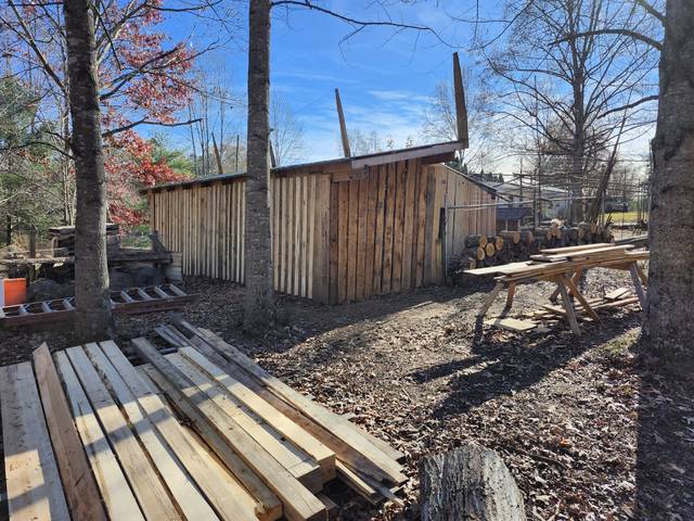 Lumber shed and stacked boards